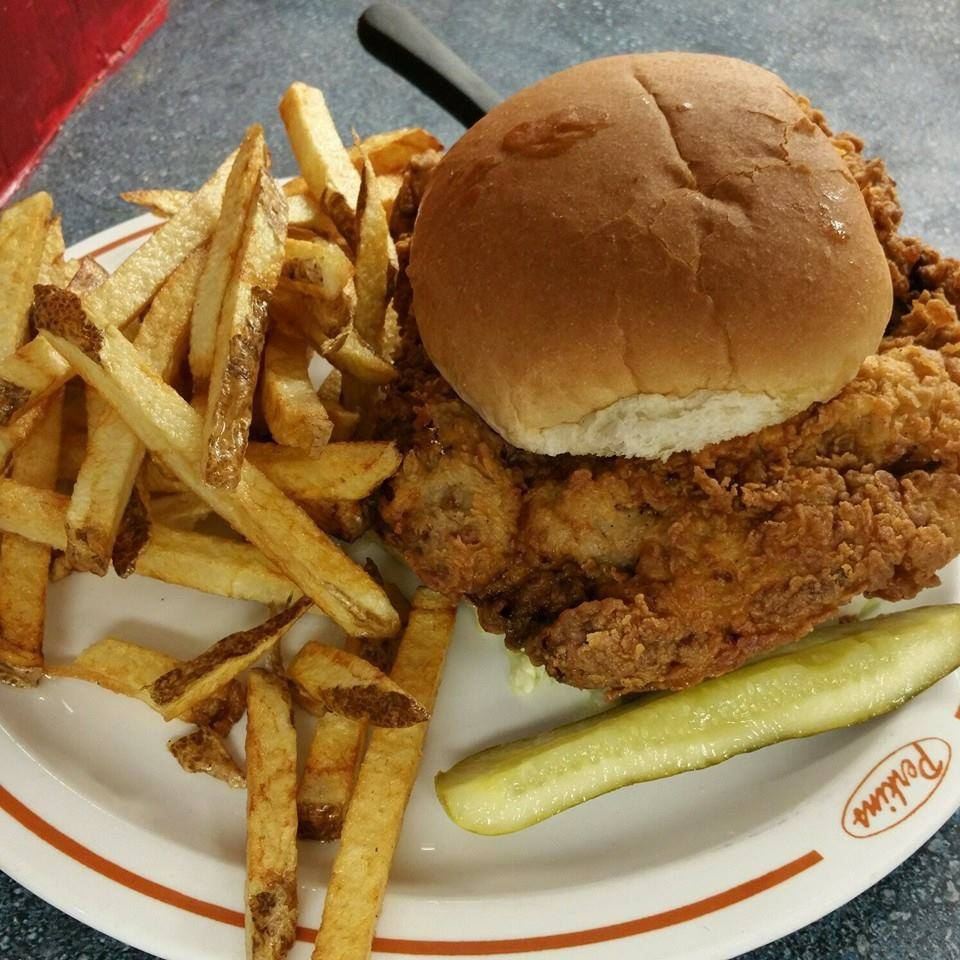 Breaded sandwich with hand-cut fries and a pickle spear