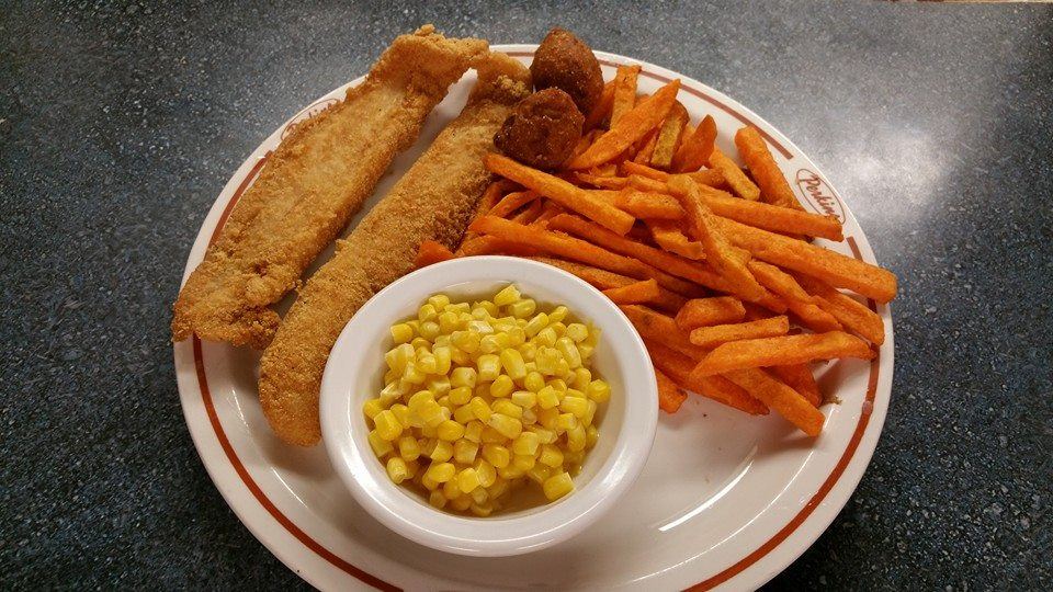 Fried fish plate with sweet potato fries, corn and hushpuppies